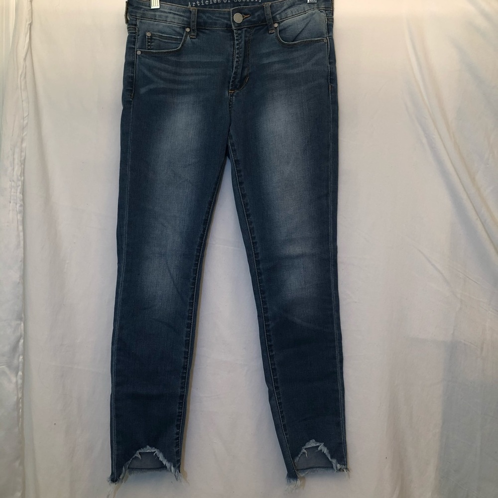 Women’s blue jeans with ripped ankles.